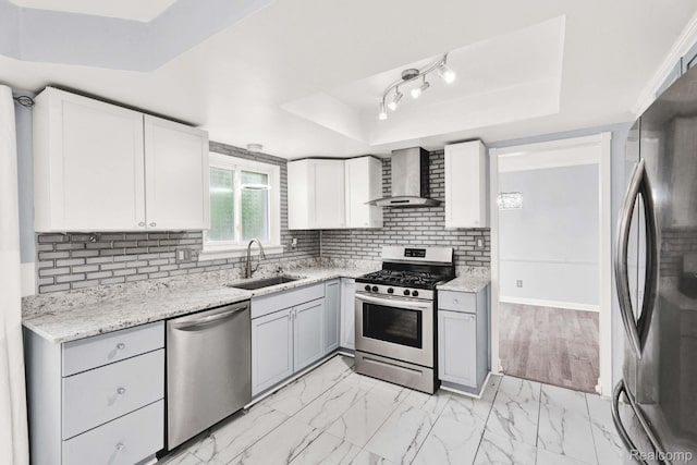 14717 Dane Ct, Sterling Heights, MI 48312 - kitchen featuring appliances with stainless steel finishes, a raised ceiling, wall chimney exhaust hood, and backsplash