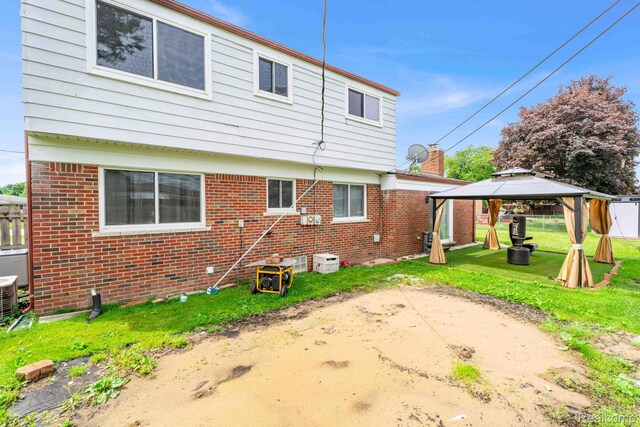 14717 Dane Ct, Sterling Heights, MI 48312 - back of house with a gazebo, brick siding, and a patio area