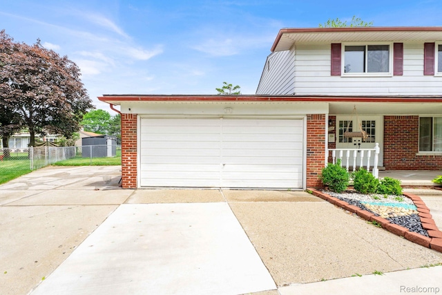 14717 Dane Ct, Sterling Heights, MI 48312 - view of front of property with concrete driveway, brick siding, and an attached garage