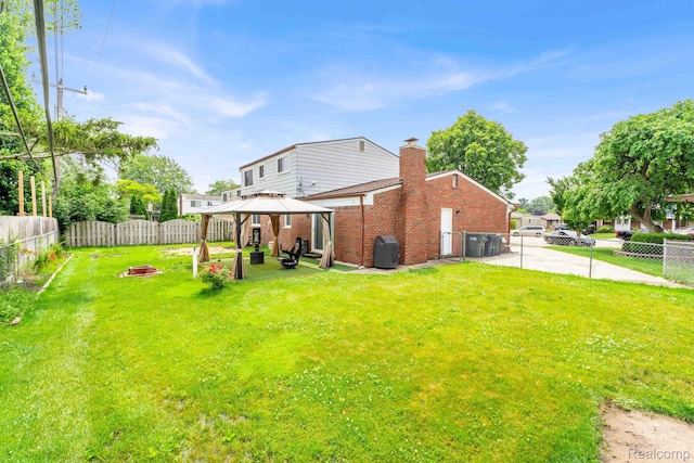 14717 Dane Ct, Sterling Heights, MI 48312 - back of house featuring a gazebo, brick siding, a fenced backyard, a patio, and a chimney