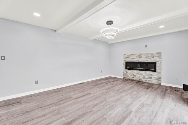 14717 Dane Ct, Sterling Heights, MI 48312 - unfurnished living room featuring beamed ceiling, wood finished floors, and a glass covered fireplace