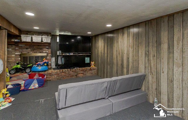 1151 July Dr, Adrian, MI 49221 - living area with wooden walls, a brick fireplace, carpet, and recessed lighting