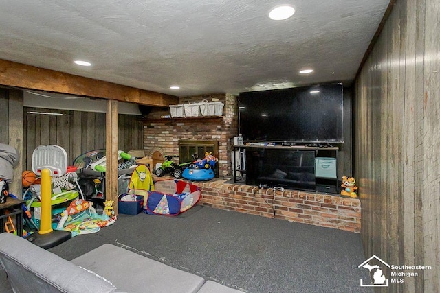 1151 July Dr, Adrian, MI 49221 - rec room featuring wood walls, a brick fireplace, carpet flooring, and recessed lighting