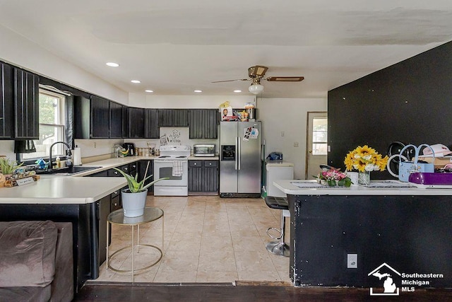 1151 July Dr, Adrian, MI 49221 - kitchen with stainless steel appliances, light countertops, a ceiling fan, dark cabinetry, and recessed lighting
