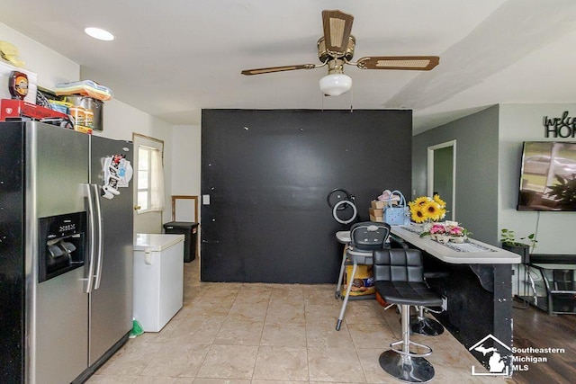1151 July Dr, Adrian, MI 49221 - kitchen with stainless steel fridge, ceiling fan, and light tile patterned flooring