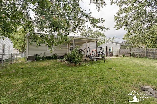 1151 July Dr, Adrian, MI 49221 - rear view of house with a fenced backyard and a gate