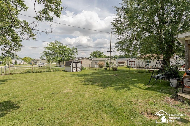1151 July Dr, Adrian, MI 49221 - fenced backyard with a shed