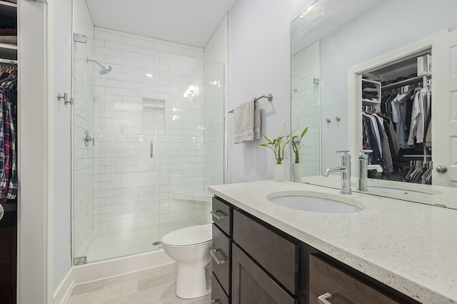2005 Celadon Dr NE Unit 12, Grand Rapids, MI 49525 - bathroom with a walk in closet, vanity, and a shower stall