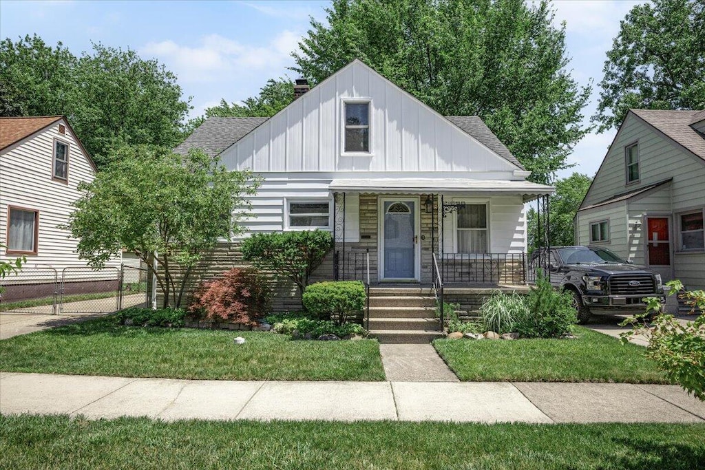 21896 Cyman Ave, Warren, MI 48091 - bungalow-style home with board and batten siding, covered porch, and roof with shingles