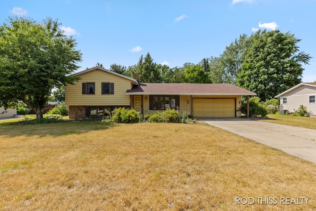 10975 Campanel Dr, Zeeland, MI 49464 - split level home featuring a garage, driveway, a front lawn, and a chimney