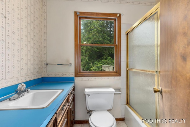 10975 Campanel Dr, Zeeland, MI 49464 - bathroom with wallpapered walls, vanity, and combined bath / shower with glass door
