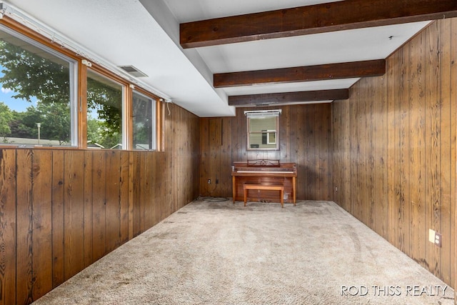 10975 Campanel Dr, Zeeland, MI 49464 - unfurnished living room featuring wooden walls, beamed ceiling, and carpet