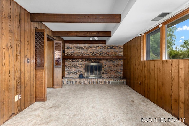 10975 Campanel Dr, Zeeland, MI 49464 - unfurnished living room featuring wooden walls, carpet, a fireplace, and beam ceiling