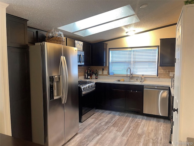 43251 Bonaparte, Sterling Heights, MI 48314 - kitchen with stainless steel appliances, lofted ceiling, a textured ceiling, light countertops, and light wood finished floors