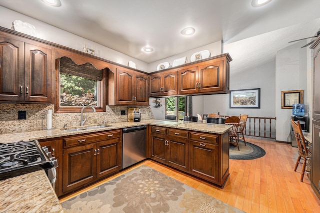 4234 N 2nd St, Kalamazoo, MI 49009 - kitchen featuring dishwasher, backsplash, gas range, light wood-style flooring, and light stone counters