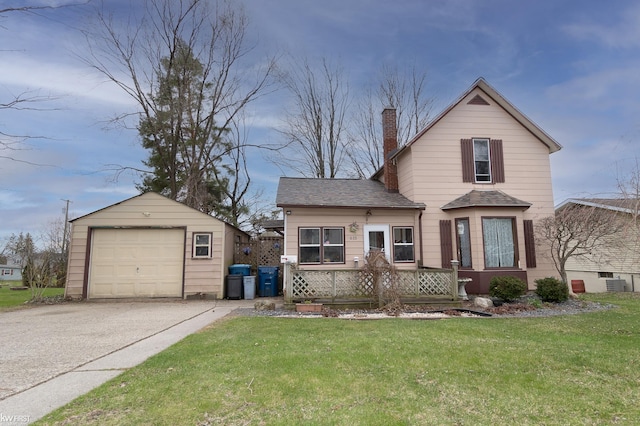 615 Saginaw St, Vassar, MI 48768 - traditional home featuring an outbuilding, a chimney, a detached garage, a front yard, and driveway