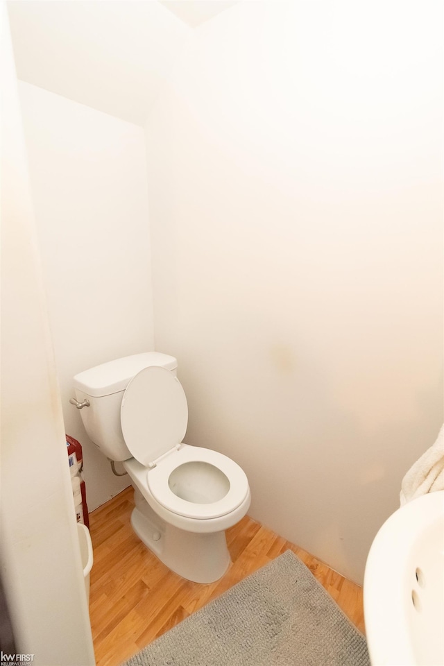 615 Saginaw St, Vassar, MI 48768 - bathroom featuring toilet and wood finished floors