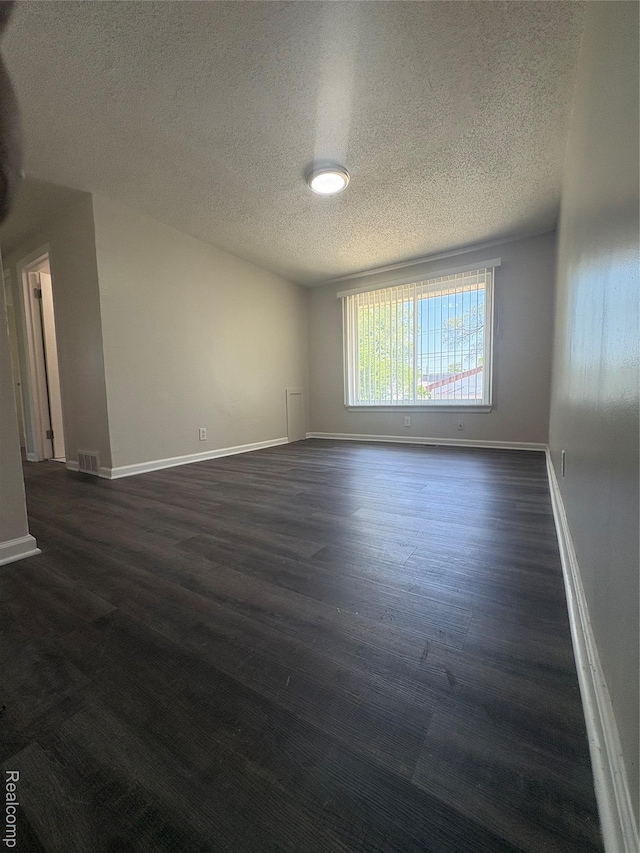 4357 Isabelle St, Inkster, MI 48141 - spare room featuring a textured ceiling and dark wood-style floors