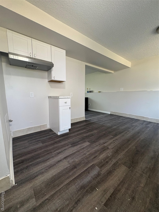 4357 Isabelle St, Inkster, MI 48141 - kitchen with under cabinet range hood, white cabinetry, a textured ceiling, dark wood-style flooring, and open floor plan
