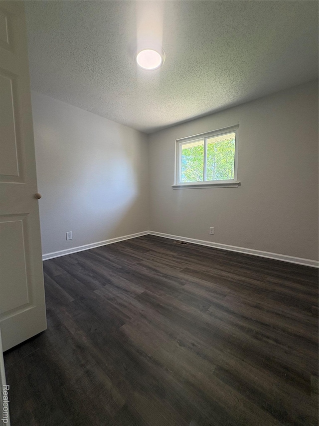 4357 Isabelle St, Inkster, MI 48141 - empty room with a textured ceiling and dark wood-style flooring