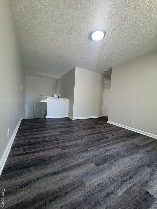 4357 Isabelle St, Inkster, MI 48141 - unfurnished living room featuring a textured ceiling and dark wood-style flooring