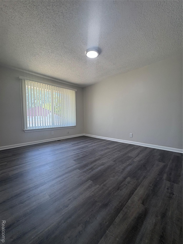 4357 Isabelle St, Inkster, MI 48141 - spare room with a textured ceiling and dark wood-style floors