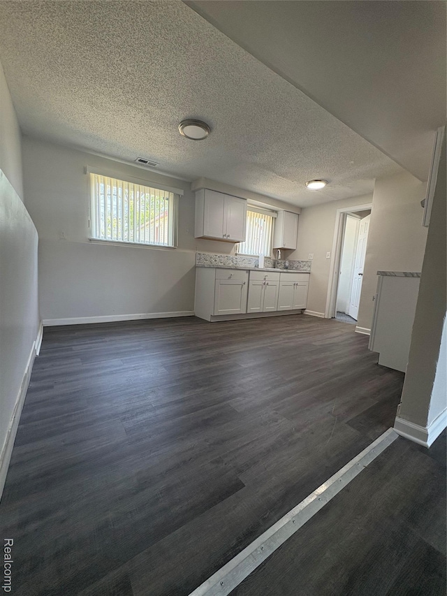 4357 Isabelle St, Inkster, MI 48141 - kitchen featuring white cabinetry, open floor plan, dark wood-type flooring, and a textured ceiling
