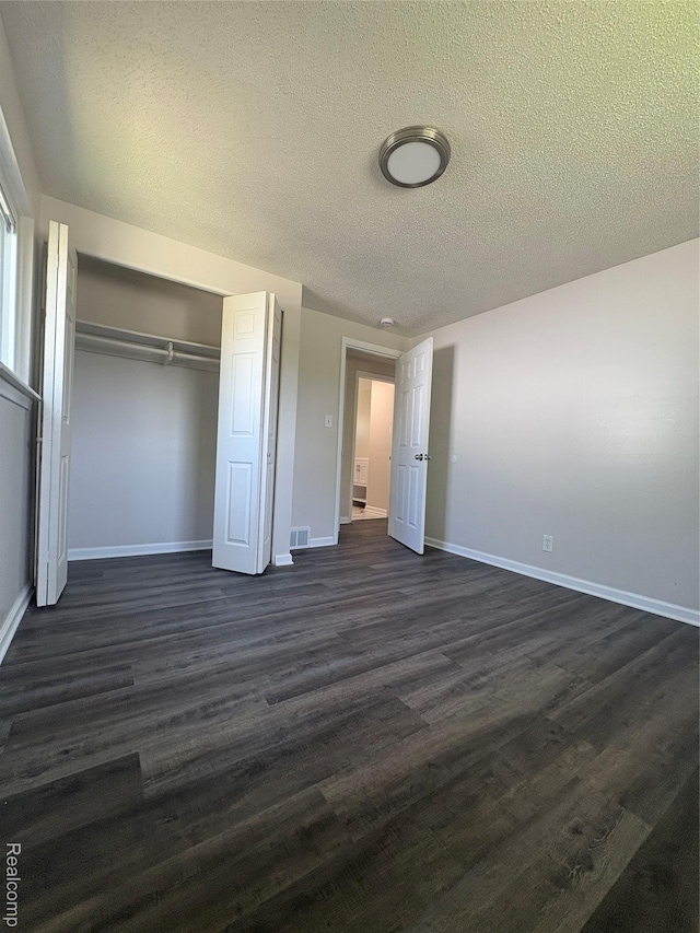 4357 Isabelle St, Inkster, MI 48141 - unfurnished bedroom with a closet, dark wood-type flooring, and a textured ceiling