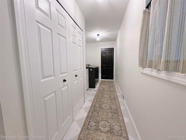 5403 Lenard Cir, Howell, MI 48843 - hallway with baseboards and washing machine and dryer