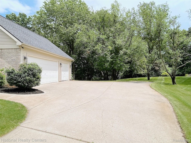 5403 Lenard Cir, Howell, MI 48843 - garage with concrete driveway