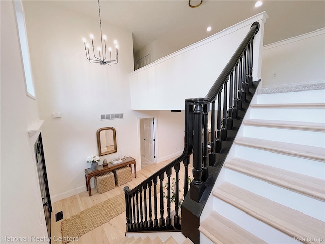 5403 Lenard Cir, Howell, MI 48843 - staircase featuring a chandelier, wood finished floors, and recessed lighting