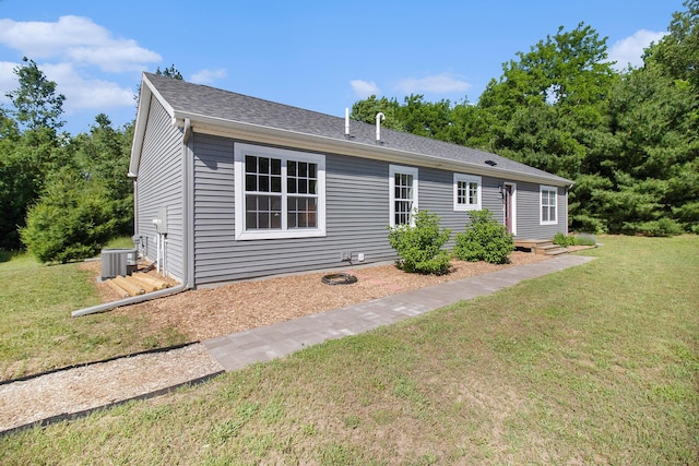 6127 River Rd, Manistee, MI 49660 - ranch-style house with a front lawn and roof with shingles
