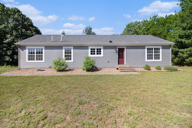 6127 River Rd, Manistee, MI 49660 - ranch-style house with a front lawn