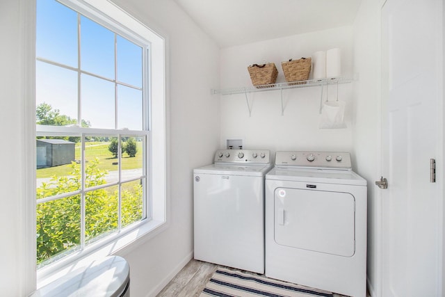 6127 River Rd, Manistee, MI 49660 - washroom with washer and clothes dryer and light wood-style floors