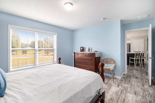6127 River Rd, Manistee, MI 49660 - bedroom with wood finished floors and baseboards