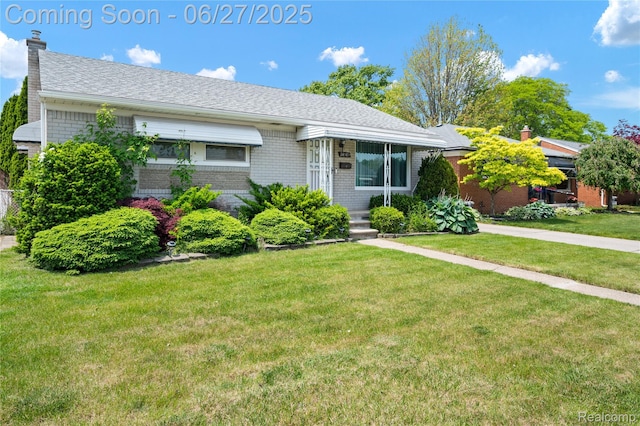 24585 Johnston Ave, Eastpointe, MI 48021 - ranch-style house featuring brick siding, a chimney, and a front yard