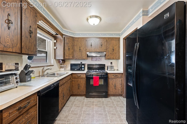 24585 Johnston Ave, Eastpointe, MI 48021 - kitchen with black appliances, under cabinet range hood, light countertops, and brown cabinets