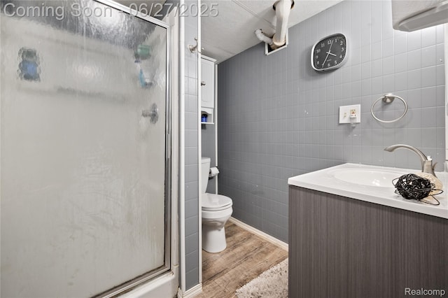 24585 Johnston Ave, Eastpointe, MI 48021 - bathroom with tile walls, wood finished floors, a shower stall, and vanity