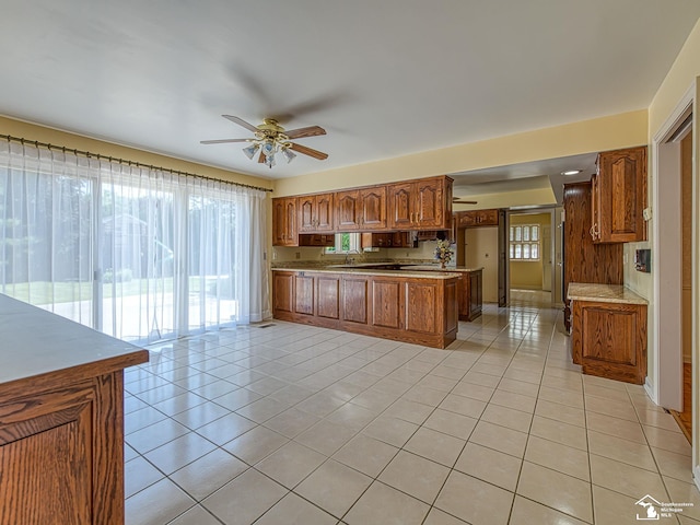 255 Maywood Ave, Monroe, MI 48162 - kitchen featuring light tile patterned floors, brown cabinets, and ceiling fan
