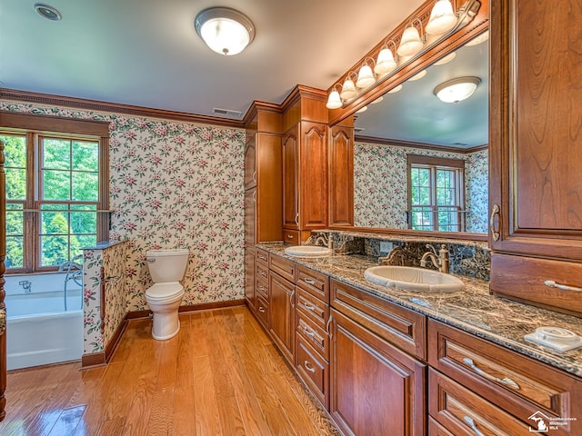 255 Maywood Ave, Monroe, MI 48162 - bathroom featuring wallpapered walls, wood finished floors, double vanity, a tub, and ornamental molding