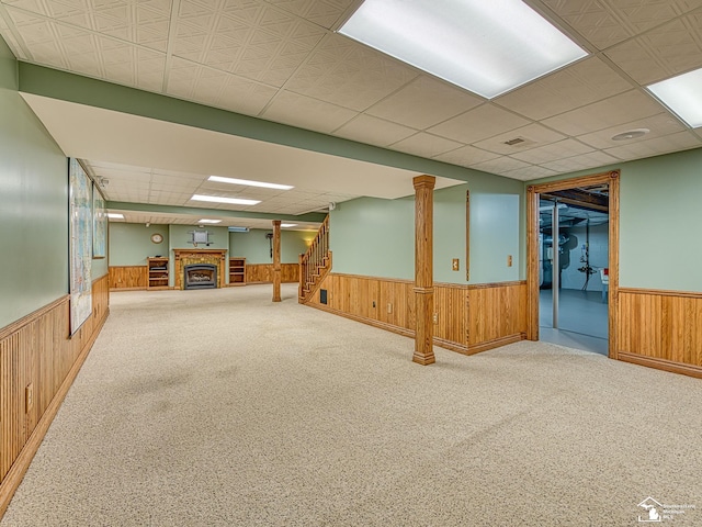 255 Maywood Ave, Monroe, MI 48162 - finished below grade area with wainscoting, wooden walls, a fireplace, stairs, and carpet