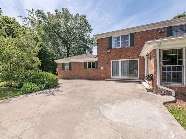 255 Maywood Ave, Monroe, MI 48162 - back of house featuring brick siding and a patio area