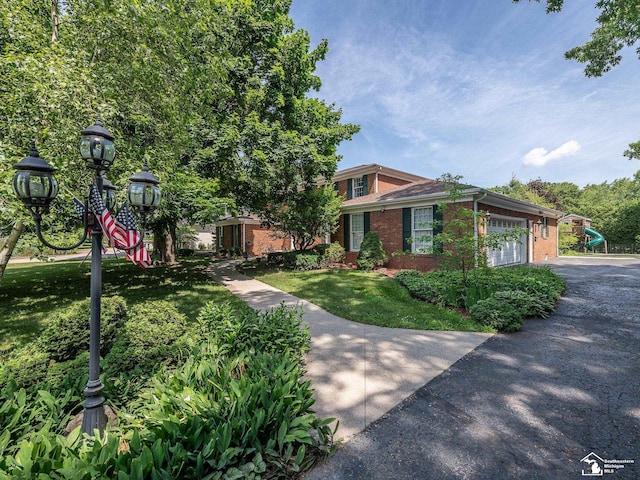 255 Maywood Ave, Monroe, MI 48162 - view of front of home with brick siding, a front lawn, and driveway