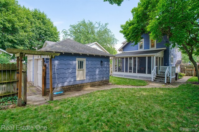 904 Michigan Ave, East Lansing, MI 48823 - back of house with a sunroom and a shingled roof