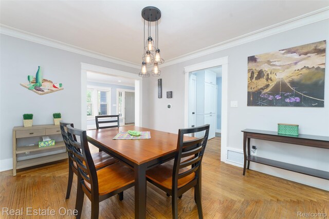 904 Michigan Ave, East Lansing, MI 48823 - dining room featuring crown molding and light wood-style flooring