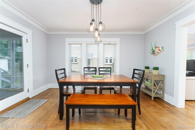904 Michigan Ave, East Lansing, MI 48823 - dining space featuring light wood-type flooring and ornamental molding