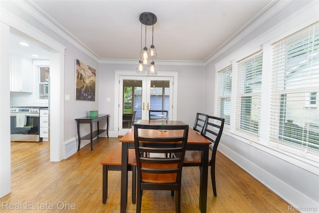 904 Michigan Ave, East Lansing, MI 48823 - dining room featuring french doors, light wood-style flooring, and ornamental molding