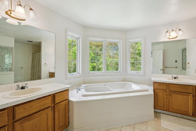 4270 Argenta Dr, Brighton, MI 48116 - bathroom with healthy amount of natural light, two vanities, a bath, and tile patterned flooring