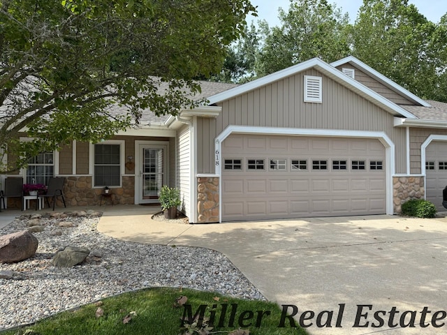 618 Riverwalk St, Hastings, MI 49058 - view of front of house featuring stone siding, a garage, concrete driveway, and roof with shingles