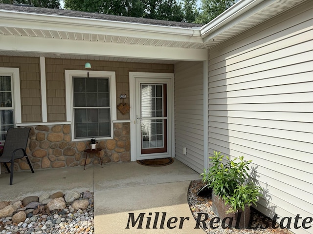 618 Riverwalk St, Hastings, MI 49058 - doorway to property with a patio area and stone siding